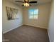 Bedroom with neutral carpet, window, ceiling fan, and light neutral paint at 2331 W Via Rialto Cir, Mesa, AZ 85202