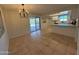 Open kitchen-dining area with stainless steel appliances and sliding glass doors at 2331 W Via Rialto Cir, Mesa, AZ 85202