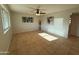 Bright living room with a ceiling fan, tile floors, and natural light at 2331 W Via Rialto Cir, Mesa, AZ 85202