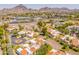 An aerial view showcasing the community's lush landscaping, desert surroundings, and nearby mountains at 2413 E Rancho Dr, Phoenix, AZ 85016