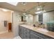 Bathroom with double vanity, granite countertop, updated lighting, and a large mirror at 2413 E Rancho Dr, Phoenix, AZ 85016