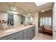 Bathroom boasts dual sinks, ample counter space, modern lighting, and ensuite Primary bedroom at 2413 E Rancho Dr, Phoenix, AZ 85016