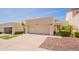 This home's exterior features a large driveway leading to the attached two-car garage and gated courtyard at 2413 E Rancho Dr, Phoenix, AZ 85016