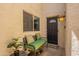 A welcoming front porch features a comfortable bench, decor, and a secured front door at 2413 E Rancho Dr, Phoenix, AZ 85016