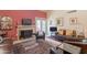 Comfortable living room features a brick fireplace, backyard access, and inviting decor at 2413 E Rancho Dr, Phoenix, AZ 85016