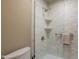 A sleek walk-in shower features a marble interior, glass enclosure, and convenient built-in shelving at 2413 E Rancho Dr, Phoenix, AZ 85016