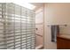 Bathroom featuring a glass block walk in shower and updated fixtures at 2413 E Rancho Dr, Phoenix, AZ 85016