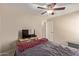 Relaxing bedroom with ceiling fan and a view of a door at 25060 W Vista Norte St, Buckeye, AZ 85326
