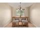Cozy dining area with a table, four chairs, and natural light from the window at 25060 W Vista Norte St, Buckeye, AZ 85326