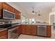An open kitchen includes stainless steel appliances and a large island with sink at 25060 W Vista Norte St, Buckeye, AZ 85326