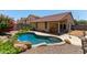 Sparkling private pool with rocky accents and mature bougainvillea at 25060 W Vista Norte St, Buckeye, AZ 85326