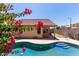 Private pool surrounded by a patio area, bougainvillea, and shade trees at 25060 W Vista Norte St, Buckeye, AZ 85326
