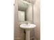 Powder room featuring a pedestal sink and a large mirror at 2509 E Meadow Land Dr, San Tan Valley, AZ 85140