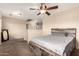 Comfortable bedroom space with a bed, fan, and a view to the outside at 2509 E Meadow Land Dr, San Tan Valley, AZ 85140