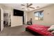 Inviting bedroom featuring soft carpeting, large window, and modern ceiling fan at 2509 E Meadow Land Dr, San Tan Valley, AZ 85140