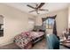Cheerful bedroom with a ceiling fan, decorated bed, and a vanity area at 2509 E Meadow Land Dr, San Tan Valley, AZ 85140