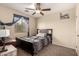 This bedroom features a bed with a desk, and a large window with light at 2509 E Meadow Land Dr, San Tan Valley, AZ 85140