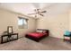 Comfortable bedroom with a ceiling fan, carpet, and window with curtains for lots of light at 2509 E Meadow Land Dr, San Tan Valley, AZ 85140