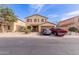 Two-story home with a front-facing two car garage and low maintenance desert landscaping at 2509 E Meadow Land Dr, San Tan Valley, AZ 85140