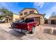 Two-story home with a front-facing two car garage and low maintenance desert landscaping at 2509 E Meadow Land Dr, San Tan Valley, AZ 85140