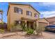 Two-story home with a front-facing two car garage and low maintenance desert landscaping at 2509 E Meadow Land Dr, San Tan Valley, AZ 85140