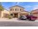 Two-story home with a front-facing two car garage and low maintenance desert landscaping at 2509 E Meadow Land Dr, San Tan Valley, AZ 85140