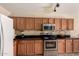 Updated kitchen featuring modern appliances, tile backsplash, and ample cabinet storage at 2509 E Meadow Land Dr, San Tan Valley, AZ 85140