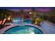 Resort style pool with rock waterfall, water slide, lush palm trees, and elevated spa at 26285 N 89Th St, Scottsdale, AZ 85255