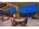 Covered patio with an outdoor kitchen, bbq, dining area, string lights and gorgeous pool views at 26285 N 89Th St, Scottsdale, AZ 85255