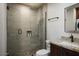 Stylish bathroom features a glass walk-in shower with pebble floor and granite vanity at 26285 N 89Th St, Scottsdale, AZ 85255