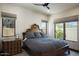 Comfortable bedroom with a large bed, natural light, and a dresser at 26285 N 89Th St, Scottsdale, AZ 85255