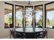 Circular dining table with seating and a stunning chandelier in a room with views of the private pool and yard at 26285 N 89Th St, Scottsdale, AZ 85255
