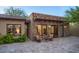 Charming stone exterior of a home with a cozy outdoor seating area and well-maintained landscaping at 26285 N 89Th St, Scottsdale, AZ 85255