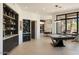 Spacious game room with pool table, built-in bar, and large windows offering natural light and views at 26285 N 89Th St, Scottsdale, AZ 85255