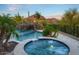Tranquil backyard with a custom pool, hot tub, cascading waterfall, and lush desert landscaping, perfect for relaxation at 26285 N 89Th St, Scottsdale, AZ 85255