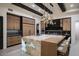 Modern kitchen with a large island with seating, gorgeous countertops, and stainless steel appliances at 26285 N 89Th St, Scottsdale, AZ 85255