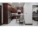 Modern kitchen with stainless steel appliances, dark cabinets, and an adjacent dining area at 26285 N 89Th St, Scottsdale, AZ 85255