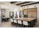 Open concept with kitchen island with barstool seating and an adjacent dining area with desert landscape artwork at 26285 N 89Th St, Scottsdale, AZ 85255