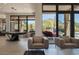 Bright living area with modern furnishings, billiard table, and sliding glass doors with desert views at 26285 N 89Th St, Scottsdale, AZ 85255
