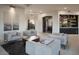 Modern living room featuring stylish gray furniture, a large window and recessed lighting for a bright, open feel at 26285 N 89Th St, Scottsdale, AZ 85255