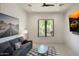 Cozy living room featuring a comfortable sofa, stylish decor, and views of the lush outdoor scenery at 26285 N 89Th St, Scottsdale, AZ 85255