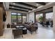 Open living room with neutral tones, a large sectional couch, and access to the outdoor living space and pool at 26285 N 89Th St, Scottsdale, AZ 85255