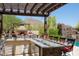 Outdoor kitchen with a grill, bar seating, and stunning views of the desert landscape at 26285 N 89Th St, Scottsdale, AZ 85255
