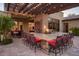 Outdoor kitchen area with granite countertops, ample seating, and lush tropical landscaping at 26285 N 89Th St, Scottsdale, AZ 85255