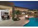 Outdoor living space with a pool, patio, outdoor kitchen, dining area, and a fire pit feature at 26285 N 89Th St, Scottsdale, AZ 85255