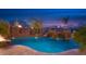 Gorgeous pool boasts a grotto, rock waterfall, water slide and night lighting at 26285 N 89Th St, Scottsdale, AZ 85255