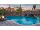 Gorgeous pool with rock features and waterfall for a resort-style backyard at 26285 N 89Th St, Scottsdale, AZ 85255