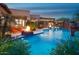 Stunning outdoor living space with a pool, fire feature, covered patio, and lush tropical landscaping at 26285 N 89Th St, Scottsdale, AZ 85255