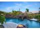 Beautiful pool with rock waterfall, fire features, and mature landscaping creates the perfect backyard at 26285 N 89Th St, Scottsdale, AZ 85255