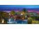 Backyard oasis with pool, rock features, fire elements and lush landscaping, perfect for evening relaxation at 26285 N 89Th St, Scottsdale, AZ 85255